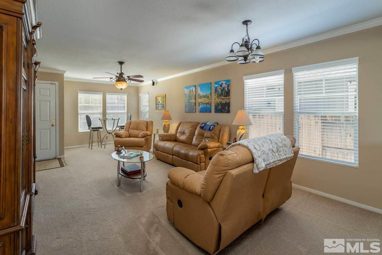 7831 Tulear Street Reno, NV 89506 - Photo 4 of 24 a living room with furniture and a chandelier