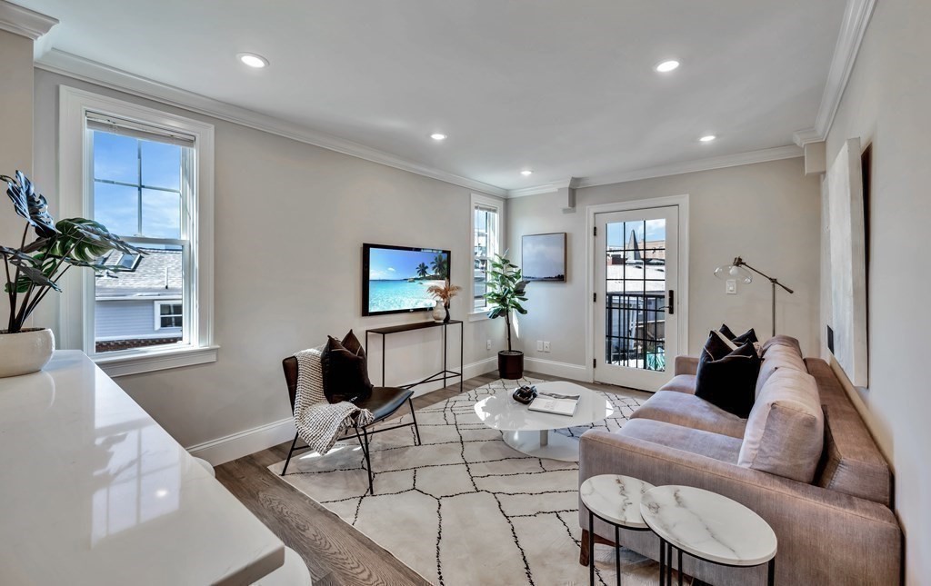 9 R Trenton Street, Unit 1 Boston, MA 02128 - Photo 3 of 15 a living room with furniture and a large window