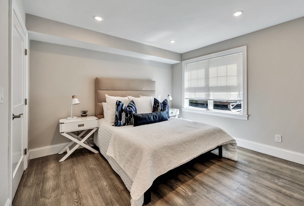 9 R Trenton Street, Unit 1 Boston, MA 02128 - Photo 5 of 15 a bedroom with a bed and wooden floor