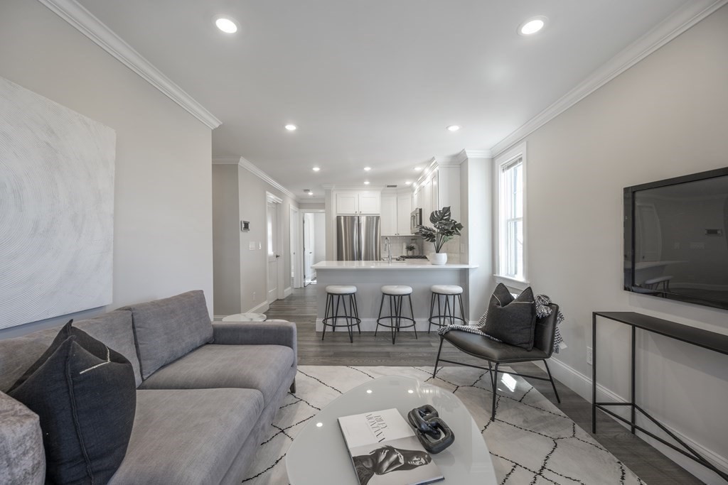 9 R Trenton Street, Unit 1 Boston, MA 02128 - Photo 6 of 15 a living room with furniture and a flat screen tv