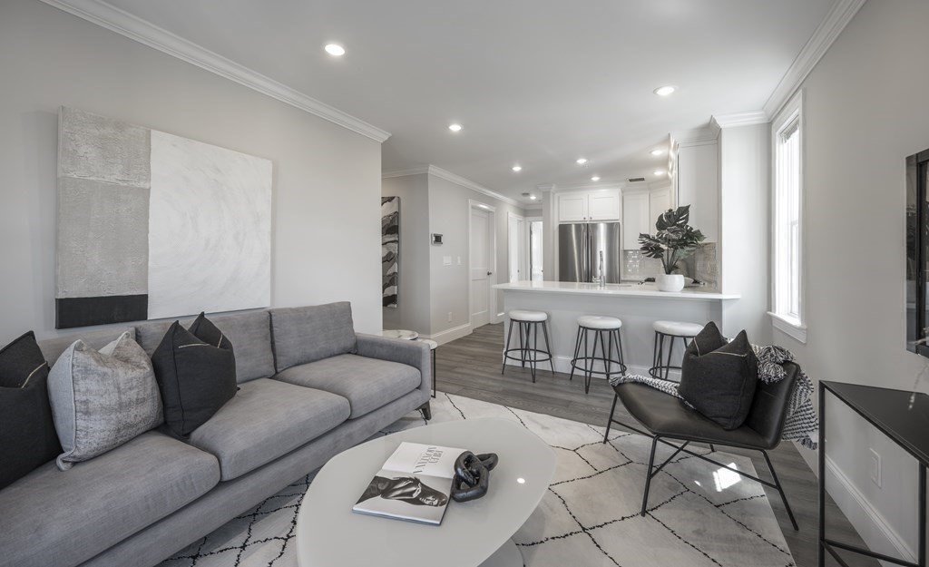 9 R Trenton Street, Unit 1 Boston, MA 02128 - Photo 7 of 15 a living room with furniture and a large window