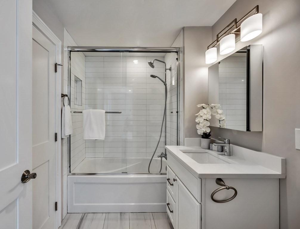 9 R Trenton Street, Unit 1 Boston, MA 02128 - Photo 9 of 15 a bathroom with a sink mirror toilet and bathtub