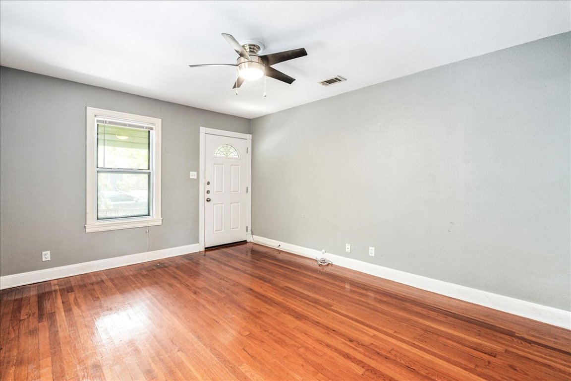3710 Hollywood Avenue Austin, TX 78722 - Photo 12 of 39 a view of an empty room with wooden floor and a window