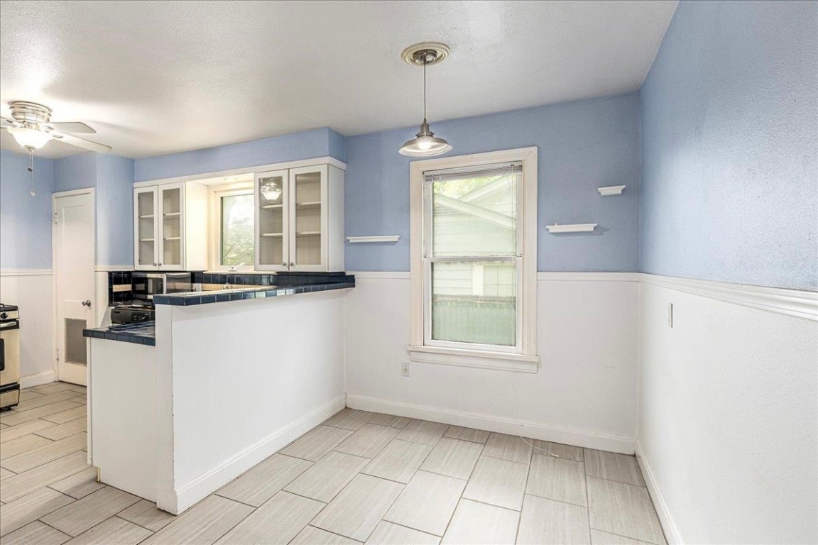 3710 Hollywood Avenue Austin, TX 78722 - Photo 16 of 39 a view of a kitchen with microwave and windows