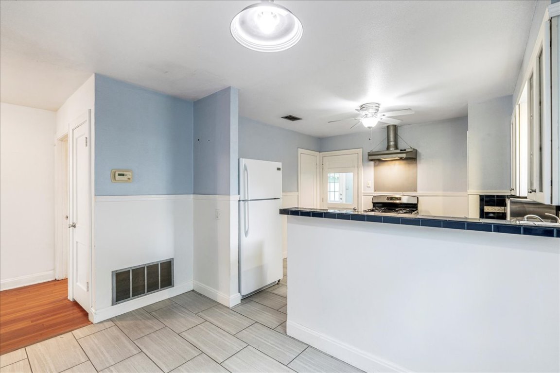 3710 Hollywood Avenue Austin, TX 78722 - Photo 17 of 39 a large kitchen with cabinets and a stainless steel appliances