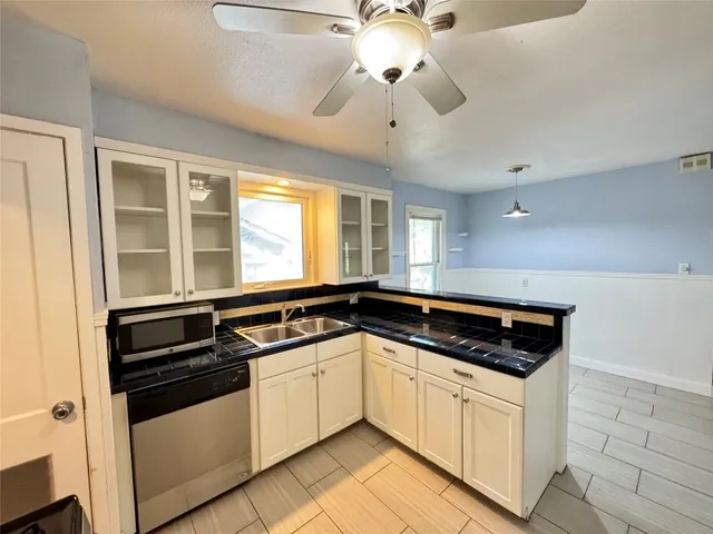 a kitchen with stainless steel appliances a stove sink and cabinets