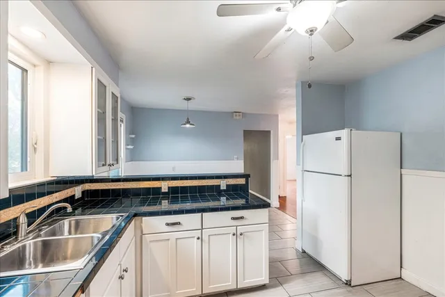 a kitchen with a refrigerator and a sink