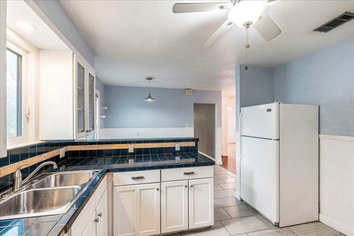 3710 Hollywood Avenue Austin, TX 78722 - Photo 20 of 39 a kitchen with a refrigerator and a sink