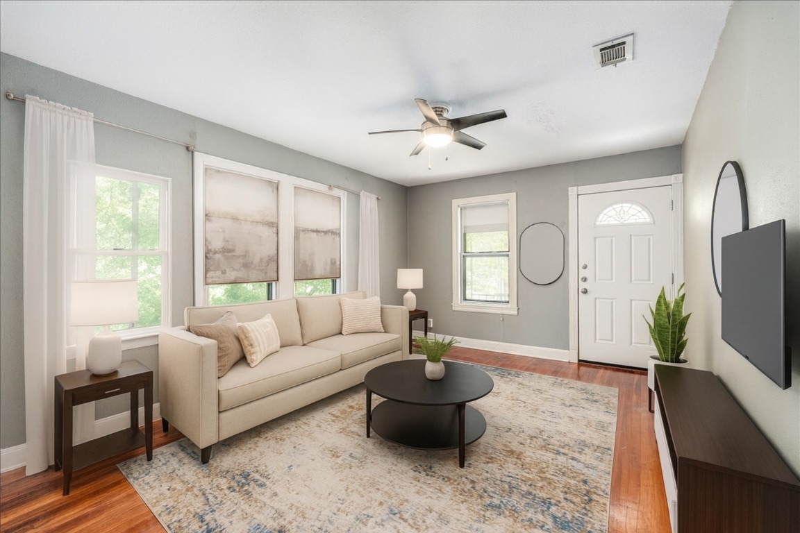 3710 Hollywood Avenue Austin, TX 78722 - Photo 2 of 39 a living room with furniture a flat screen tv and a large window