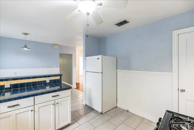 a kitchen with a refrigerator and a sink