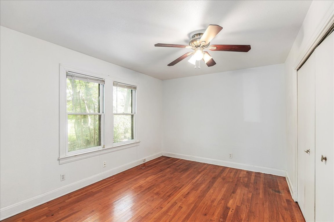 3710 Hollywood Avenue Austin, TX 78722 - Photo 26 of 39 an empty room with wooden floor fan and windows