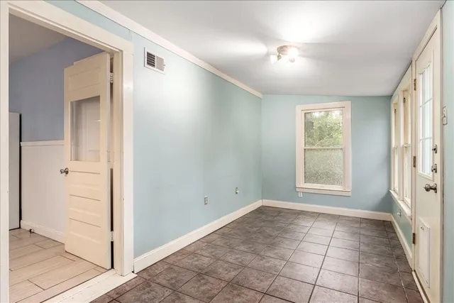an empty room with windows and closet