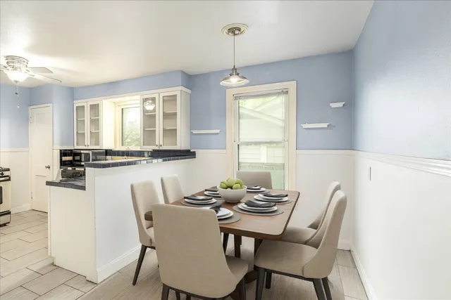 a dining room with furniture and window