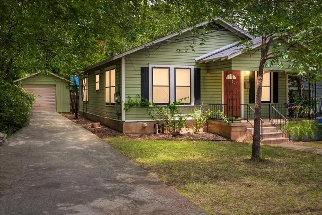 a view of a house with backyard porch and sitting area