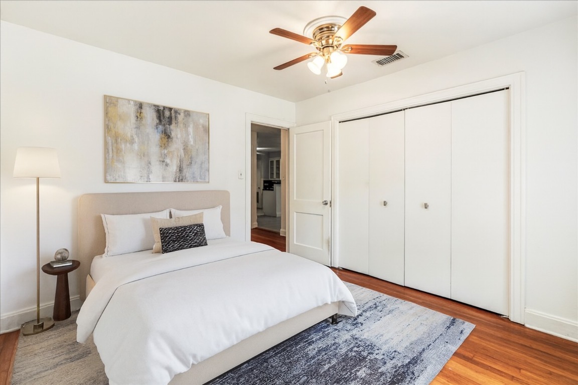 3710 Hollywood Avenue Austin, TX 78722 - Photo 6 of 39 a bedroom with a large bed and a chandelier