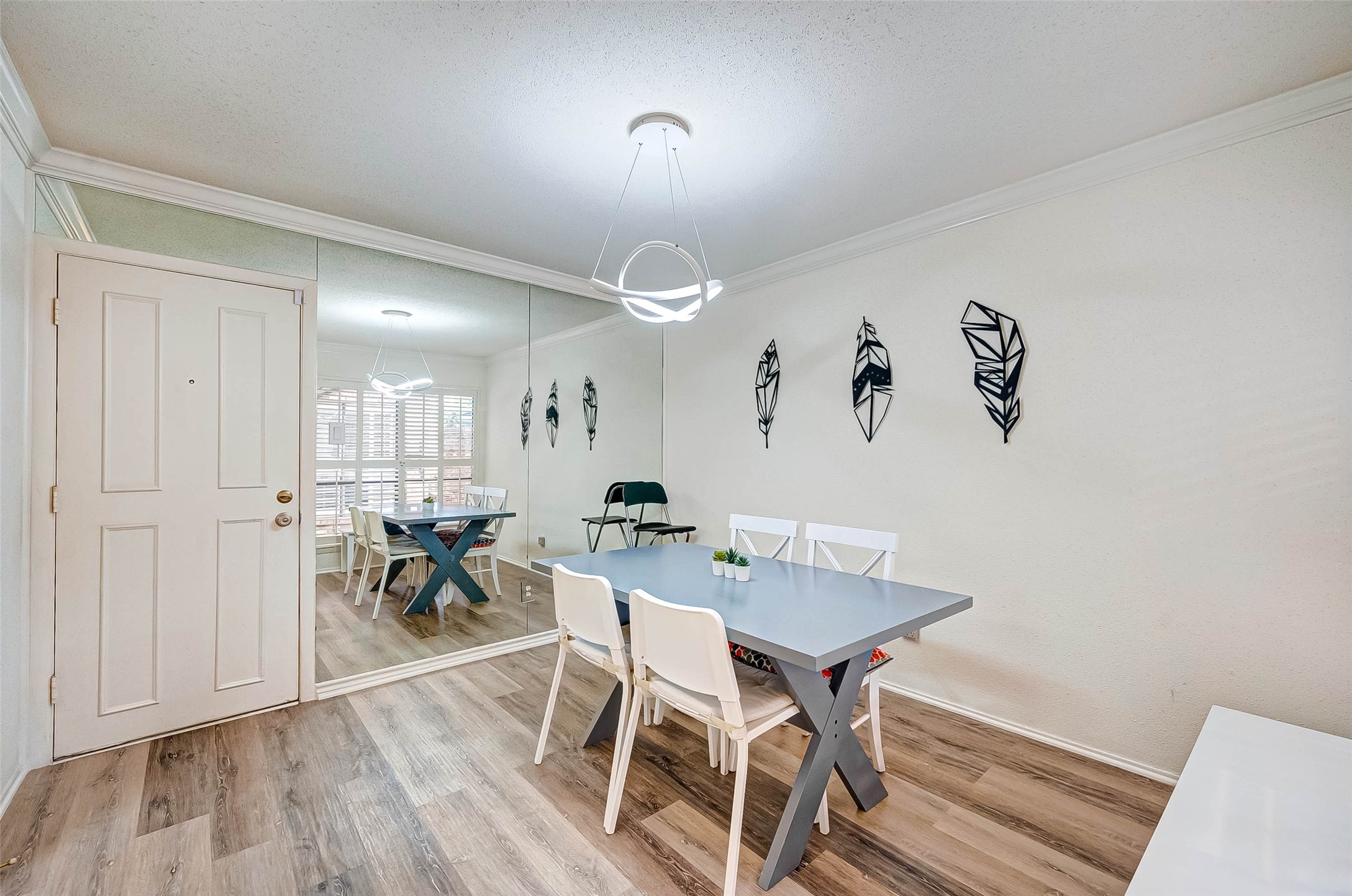 1908 Augusta Drive, Unit 7 Houston, TX 77057 - Photo 13 of 33 a view of a dining room with furniture and wooden floor