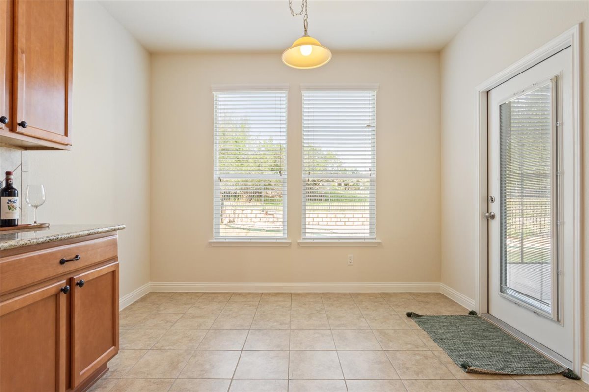 108 Cathedral Mountain Pass Georgetown, TX 78633 - Photo 11 of 36 a view of a kitchen with a dishwasher cabinets and a window