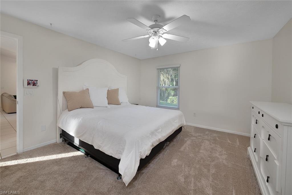 1981 Seminole Harbor Drive Alva, FL 33920 - Photo 13 of 19 a spacious bedroom with a bed and a chandelier