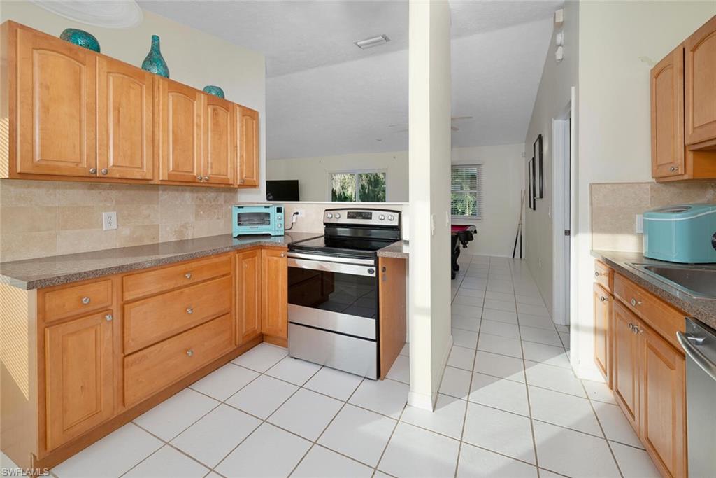 1981 Seminole Harbor Drive Alva, FL 33920 - Photo 10 of 19 a kitchen with a stove sink and cabinets