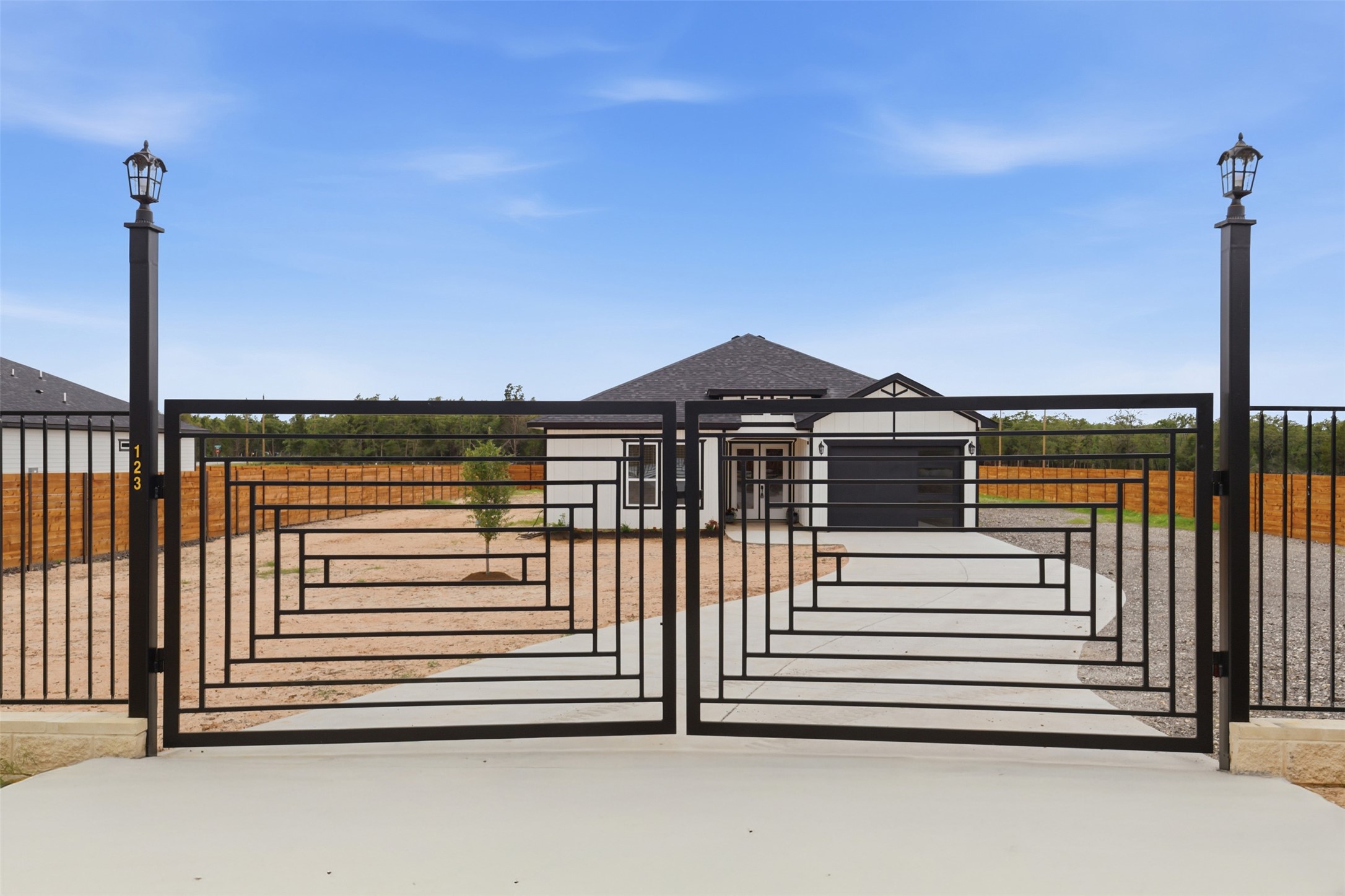 123 Los Robles Road Elgin, TX 78621 - Photo 2 of 21 Wrought iron gate with decorative geometric pattern