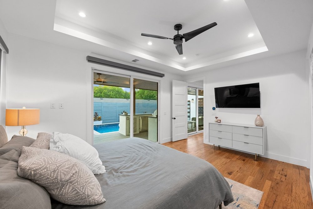 1003 Taffy Court Austin, TX 78704 - Photo 19 of 40 a bedroom with a bed and a flat screen tv