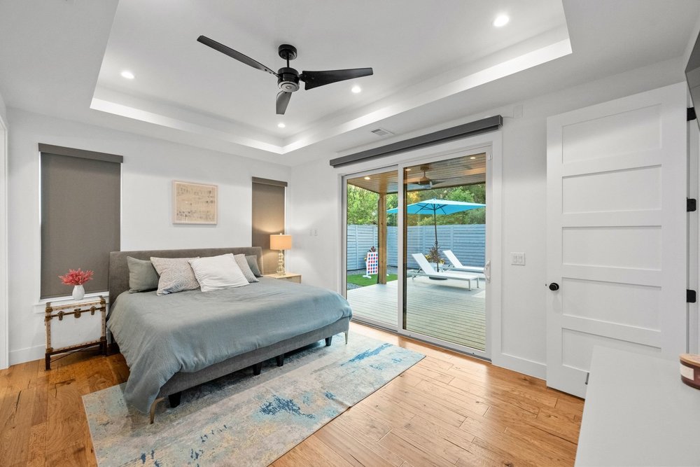 1003 Taffy Court Austin, TX 78704 - Photo 20 of 40 a bedroom with a large bed and a large window