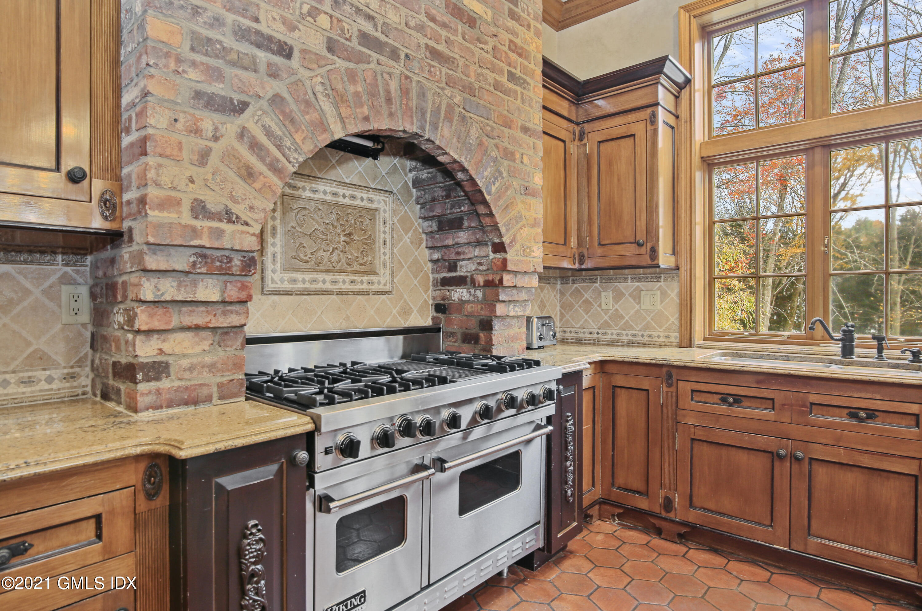 18 Lower Cross Road Greenwich, CT 06831 - Photo 19 of 40 a kitchen with stainless steel appliances granite countertop a stove and a sink