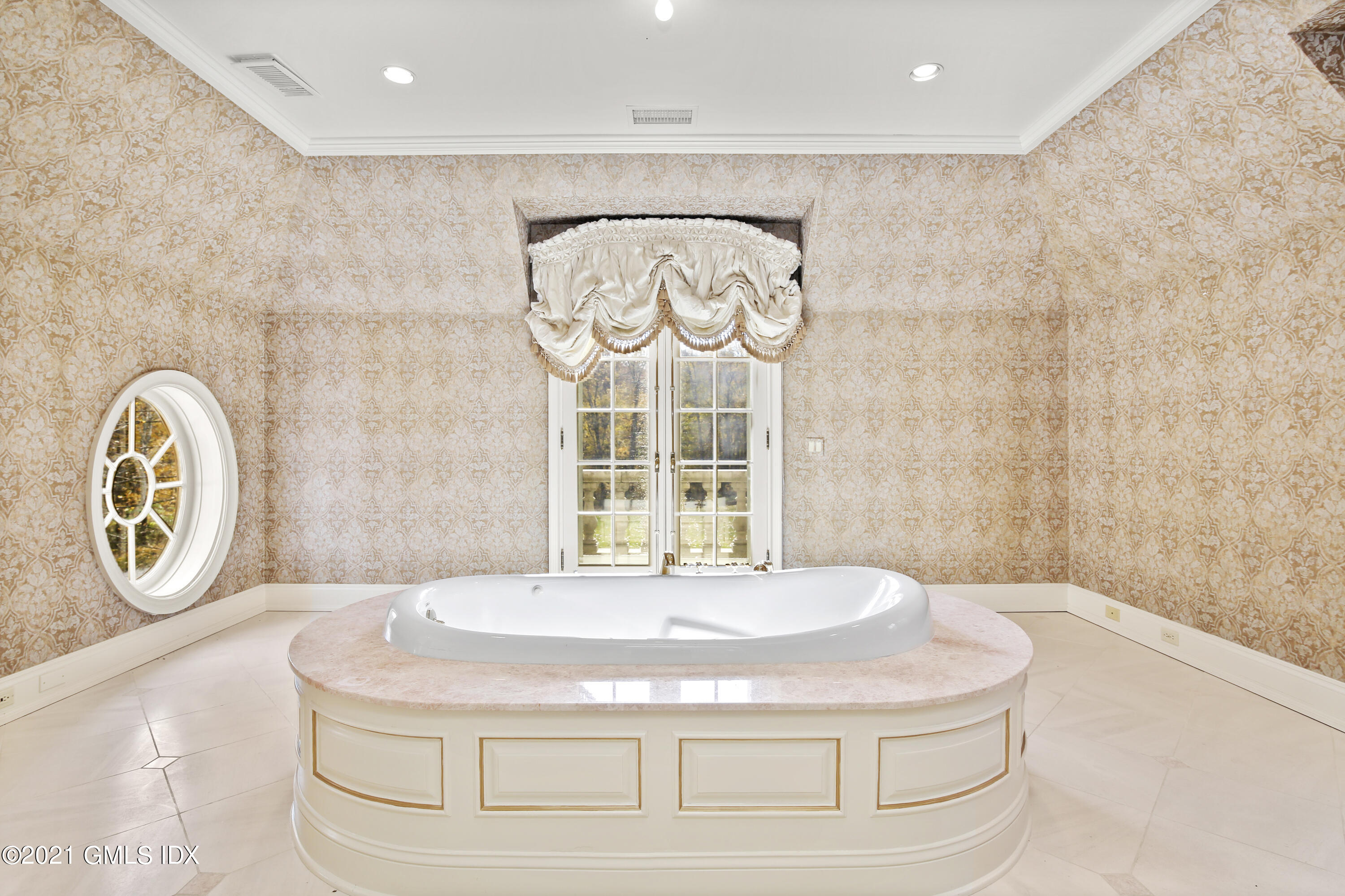 18 Lower Cross Road Greenwich, CT 06831 - Photo 25 of 40 a bed sitting in a spacious bathroom next to a window