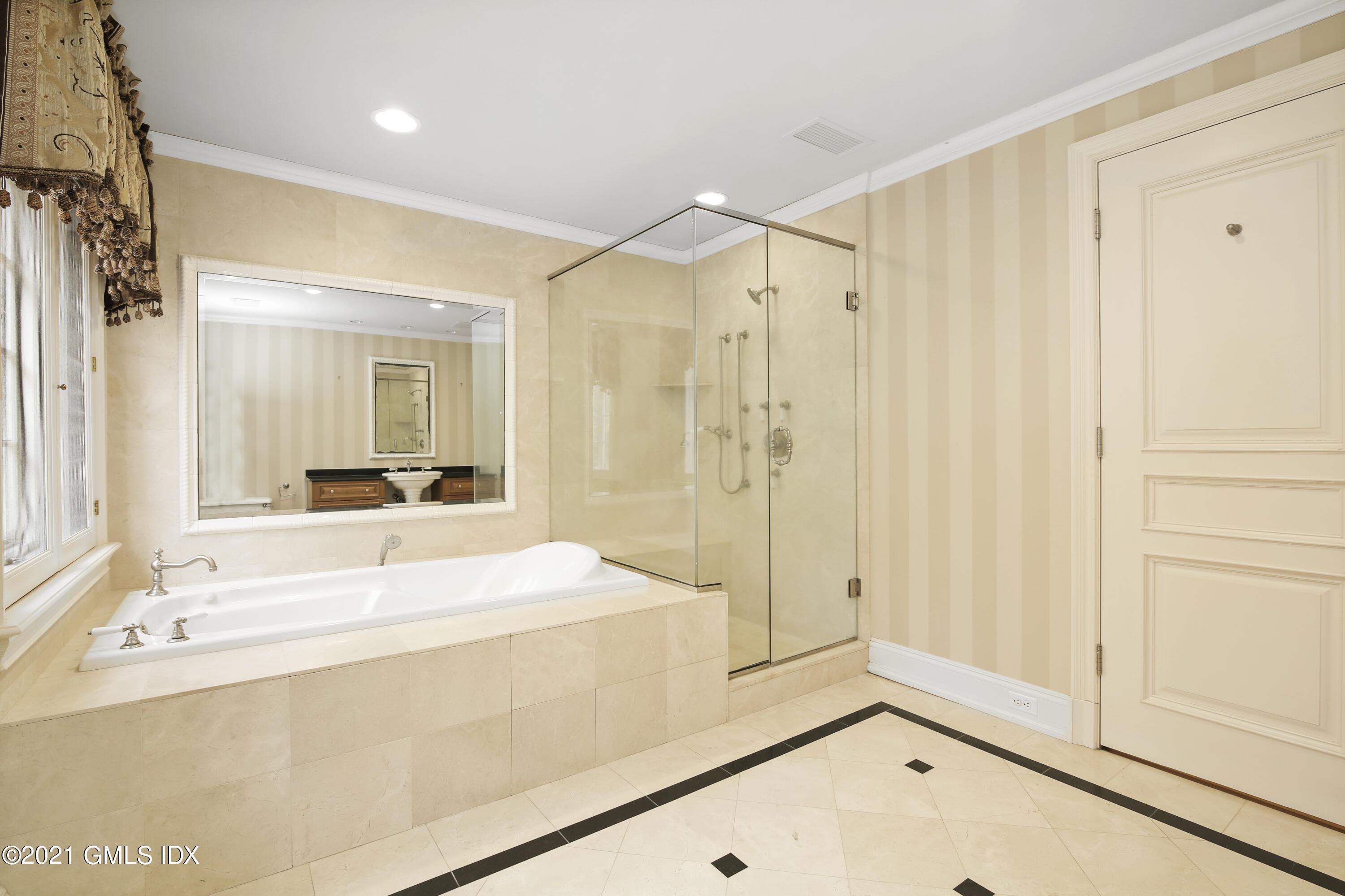 18 Lower Cross Road Greenwich, CT 06831 - Photo 28 of 40 a bathroom with a tub shower and sink