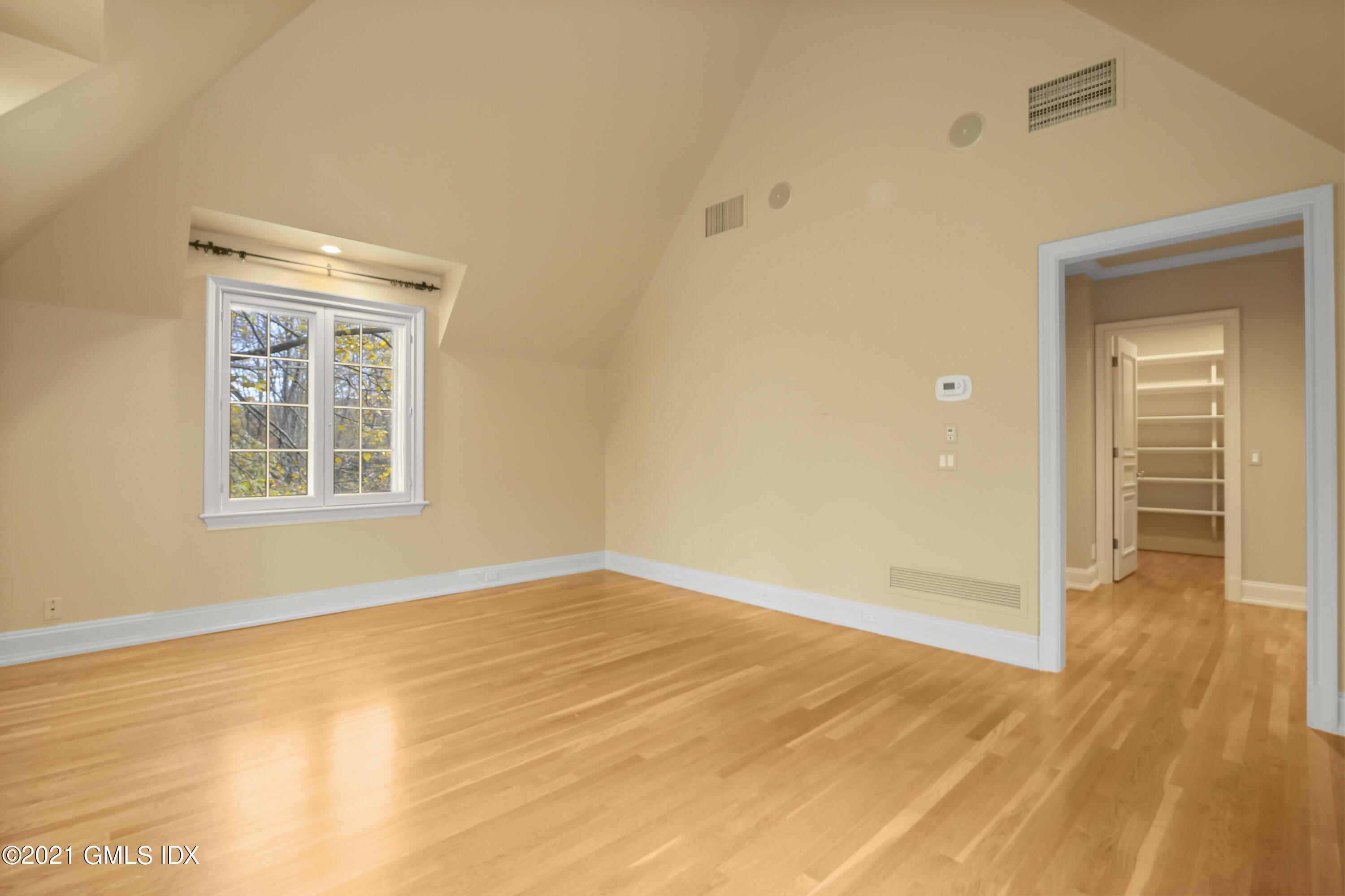 18 Lower Cross Road Greenwich, CT 06831 - Photo 29 of 40 a view of an empty room with wooden floor and a window