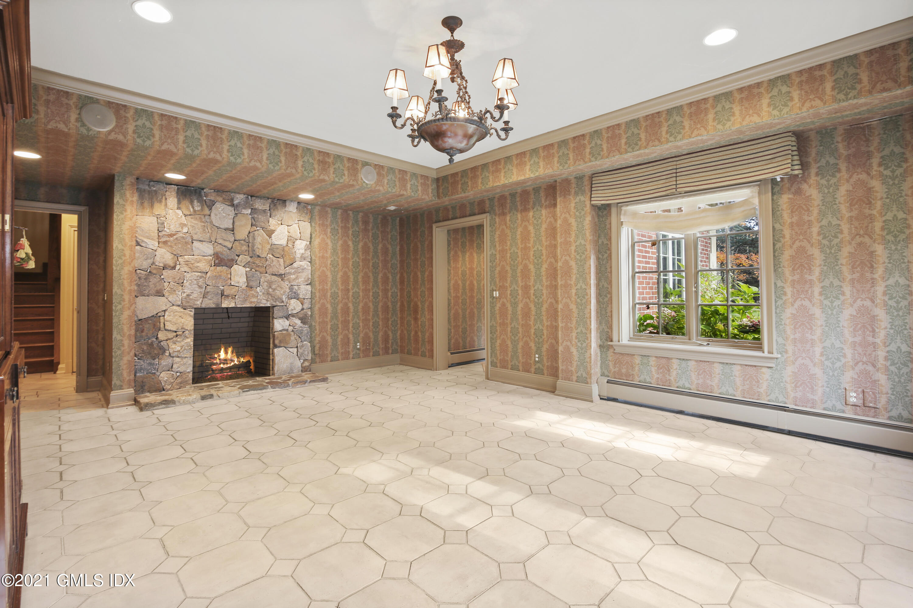 18 Lower Cross Road Greenwich, CT 06831 - Photo 32 of 40 a view of an empty room with a fireplace and a window