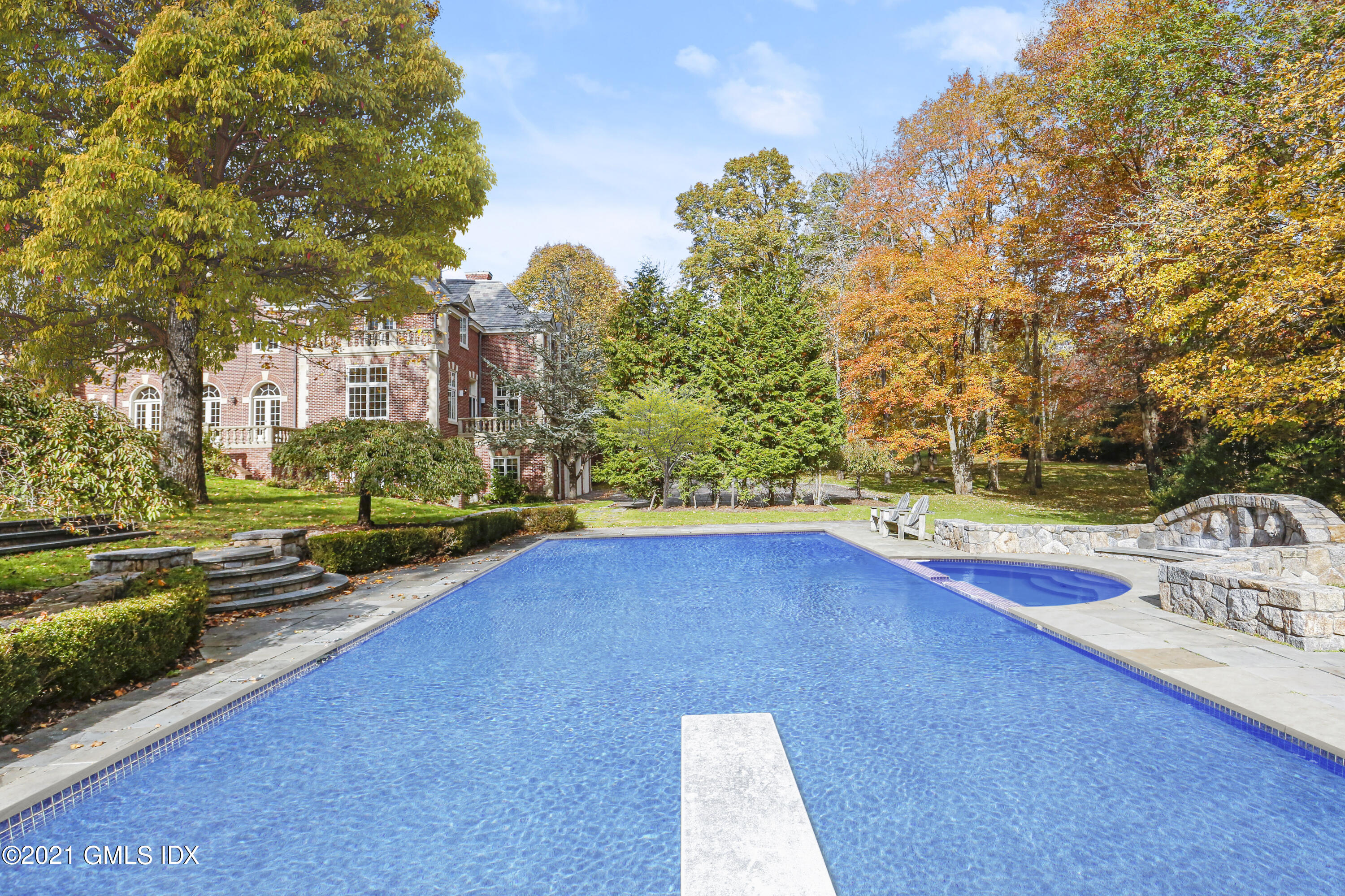 18 Lower Cross Road Greenwich, CT 06831 - Photo 36 of 40 a view of a house with swimming pool and sitting area