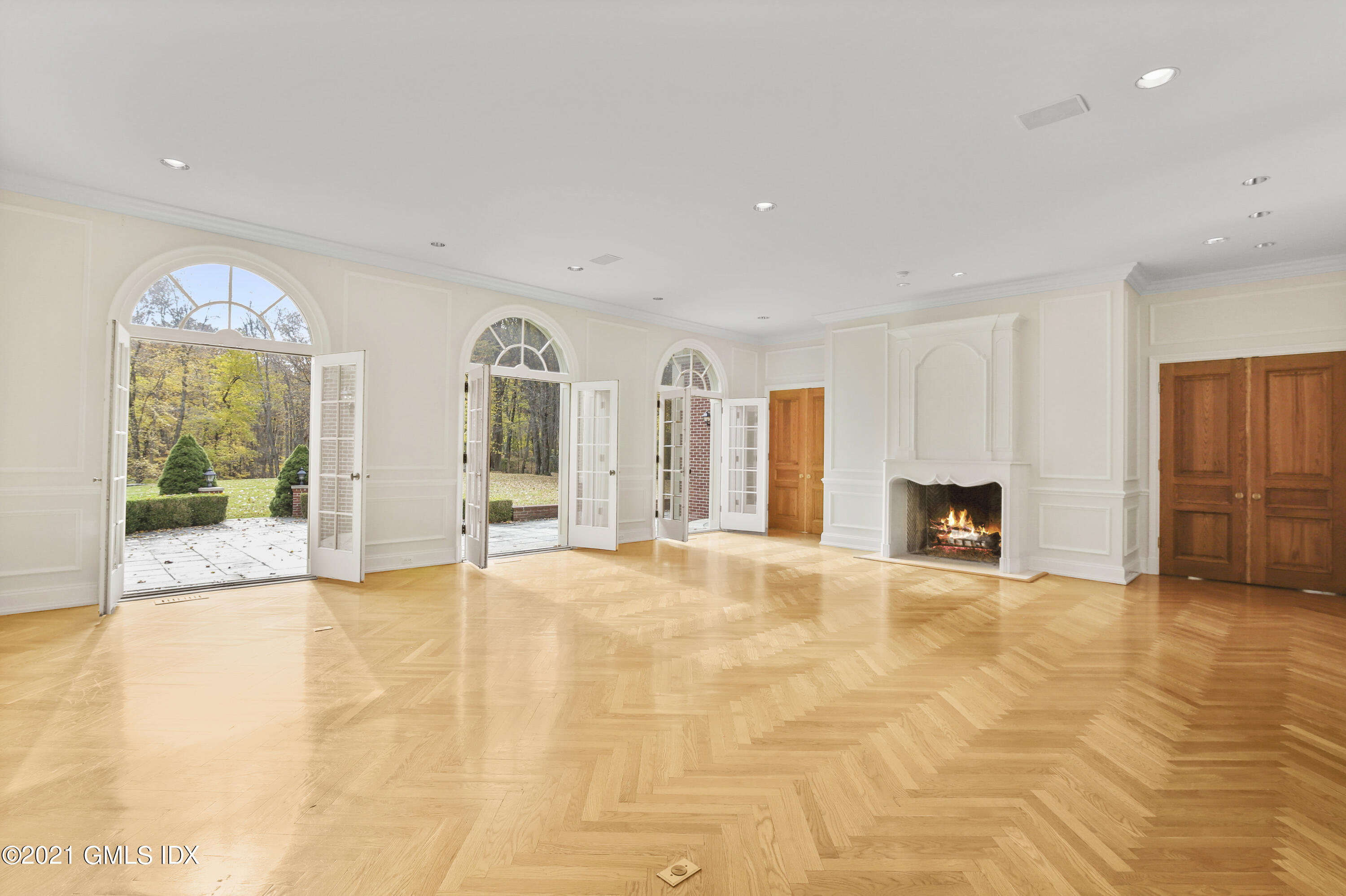 18 Lower Cross Road Greenwich, CT 06831 - Photo 5 of 40 a view of an empty room with a fireplace and a window
