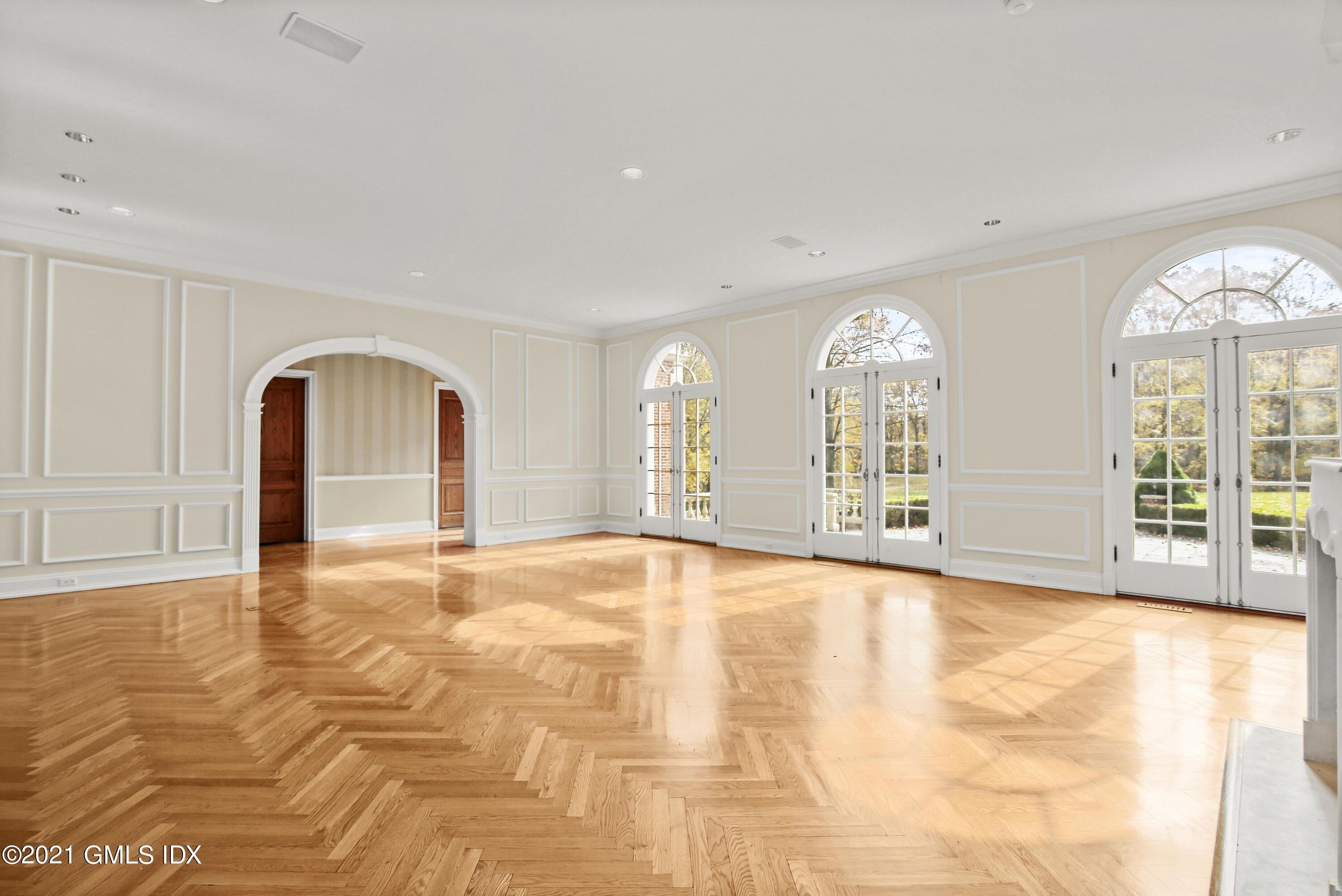 18 Lower Cross Road Greenwich, CT 06831 - Photo 6 of 40 a view of an empty room with a fireplace and a large window