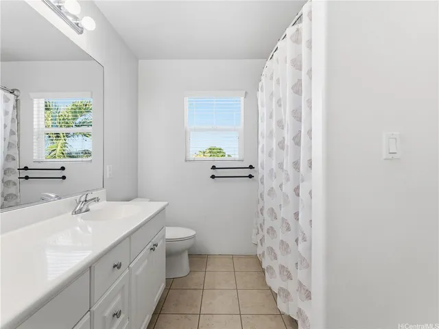 a spacious bathroom with a granite countertop sink a mirror and a shower