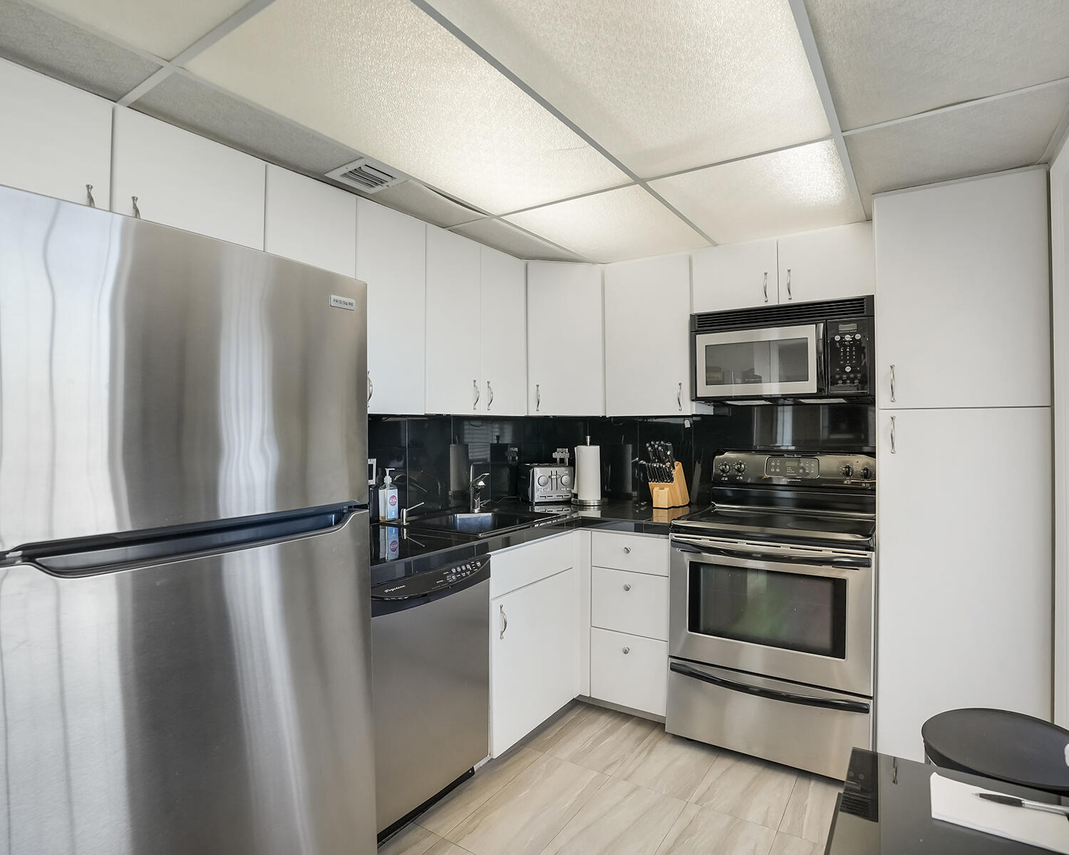 2671 South Course Drive, Unit 907 Pompano Beach, FL 33069 - Photo 11 of 21 a kitchen with stainless steel appliances and refrigerator