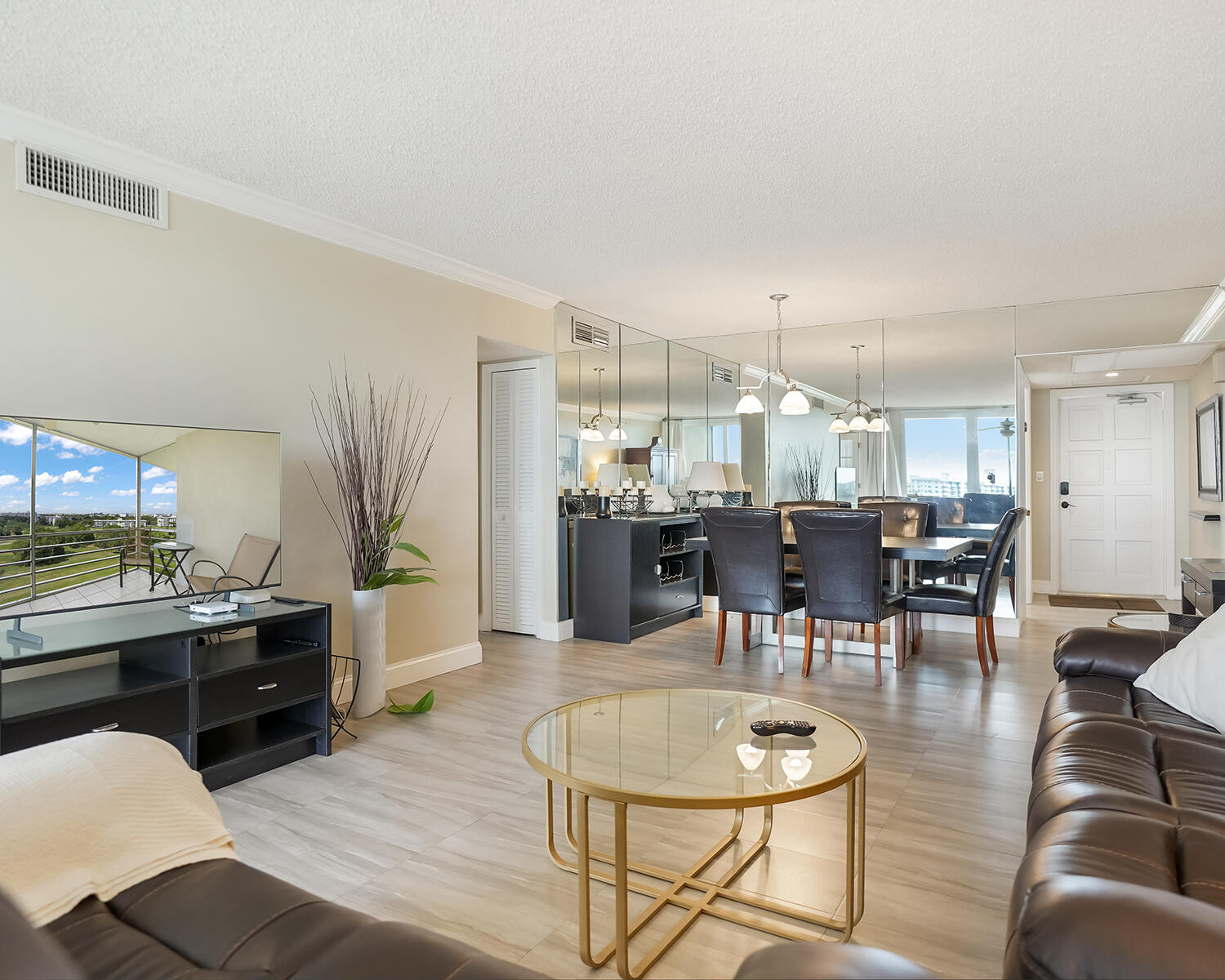 2671 South Course Drive, Unit 907 Pompano Beach, FL 33069 - Photo 14 of 21 a dining room with wooden floor and kitchen view