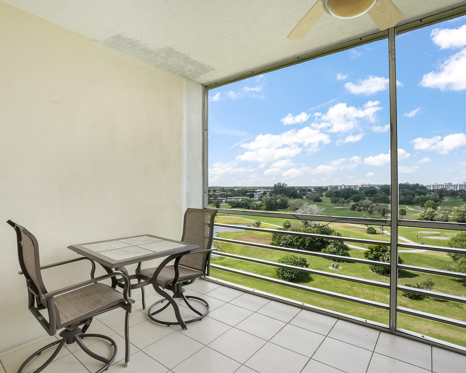 2671 South Course Drive, Unit 907 Pompano Beach, FL 33069 - Photo 19 of 21 a view of a chairs and table in a balcony