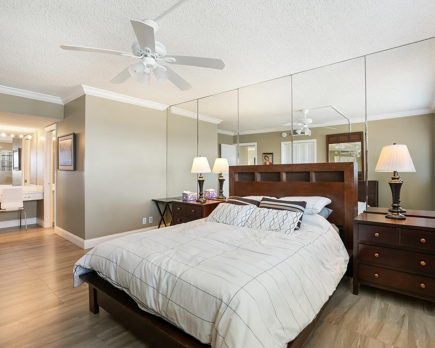 2671 South Course Drive, Unit 907 Pompano Beach, FL 33069 - Photo 7 of 21 a bedroom with a bed and a chandelier