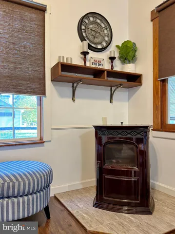 a kitchen with a white refrigerator a sink a stove and white cabinets