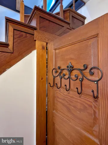 a view of hallway with stairs and wooden floor