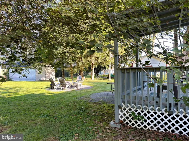 a view of a house with backyard sitting area and garden
