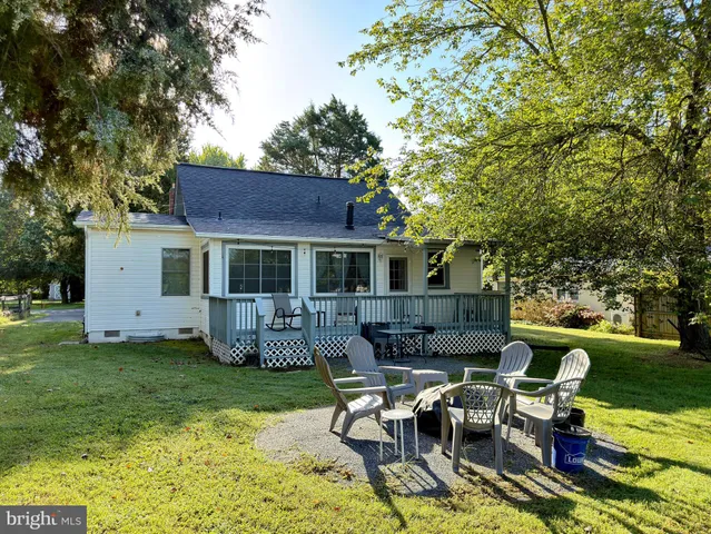 a living room with a stove and a dining table next to a window