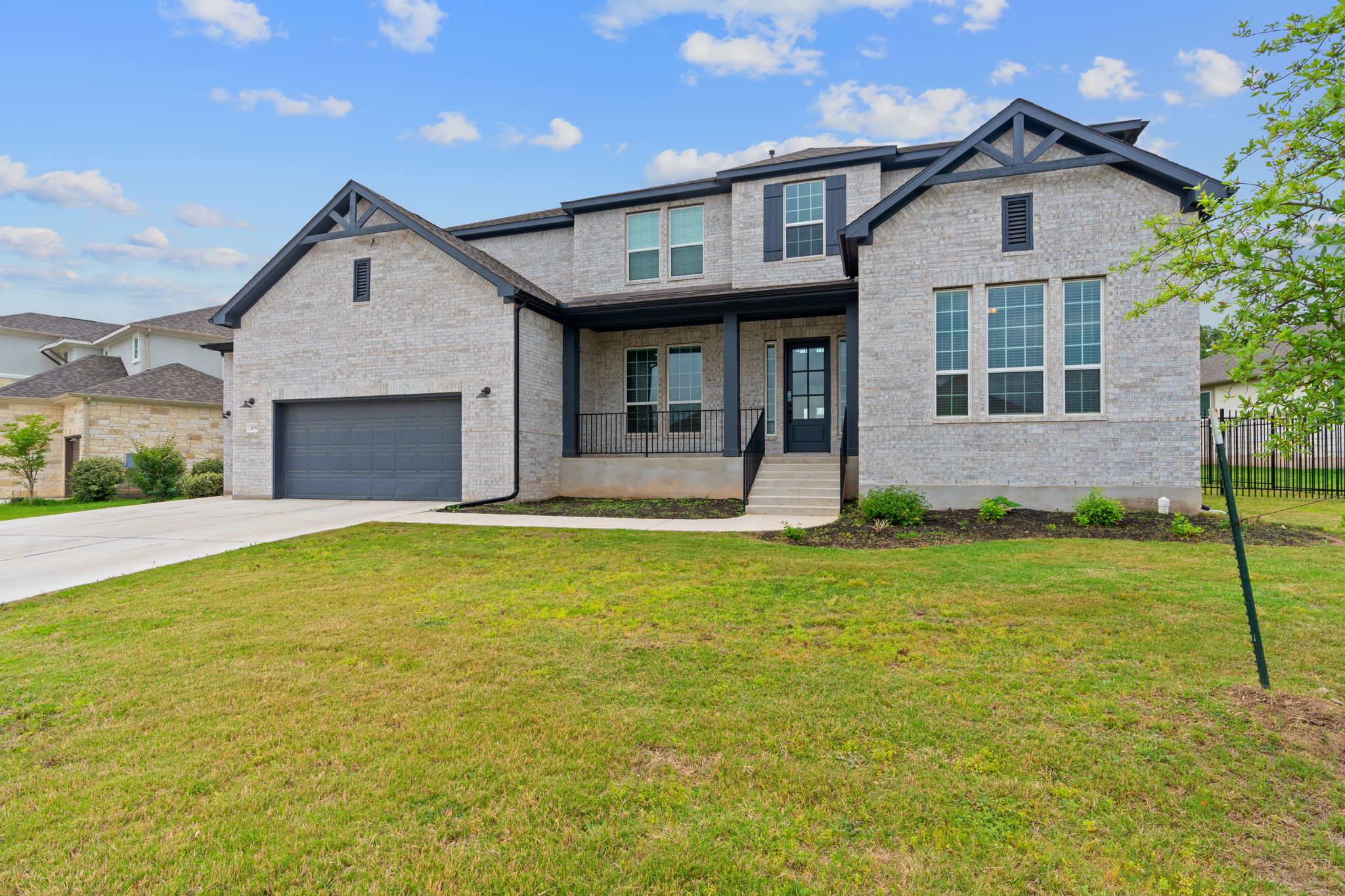 309 Pear Tree Lane Austin, TX 78737 - Photo 2 of 39 a front view of a house with garden