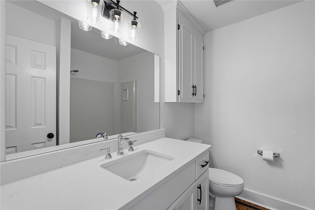 208 Williamsburg Road Anderson, SC 29621 - Photo 32 of 48 A crisp white vanity with stone counters anchors this modern washroom.