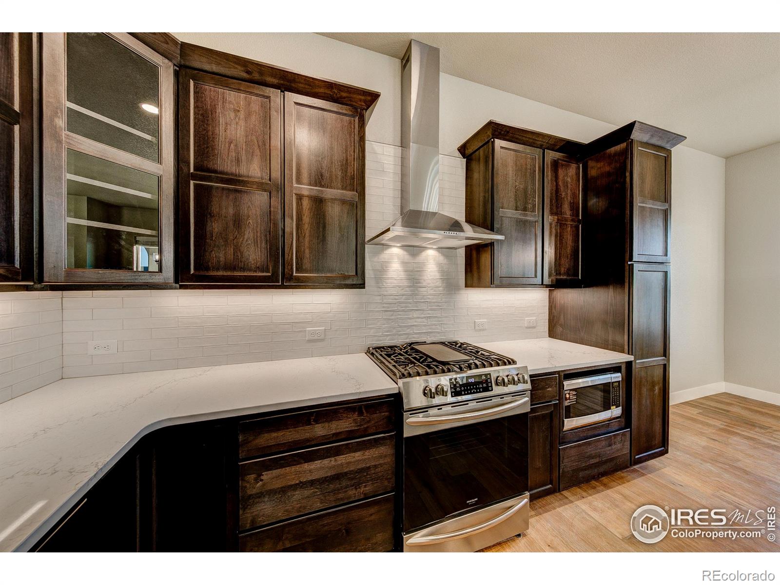 6227 Vernazza Way, Unit 4 Windsor, CO 80550 - Photo 8 of 15 a kitchen with granite countertop a stove and a refrigerator