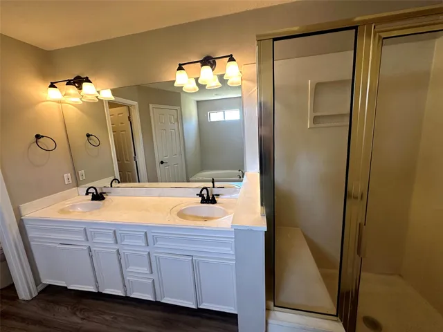 a bathroom with a double vanity sink and mirror