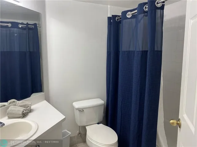 a white toilet sitting next to a bathroom sink