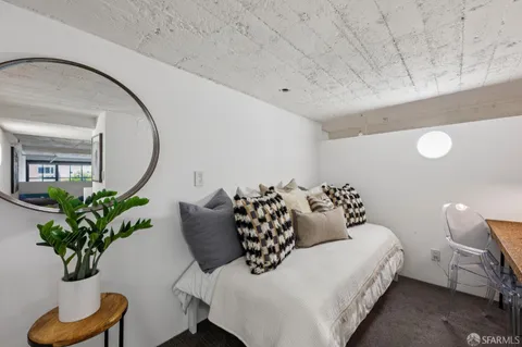 a bedroom with bed and a potted plant