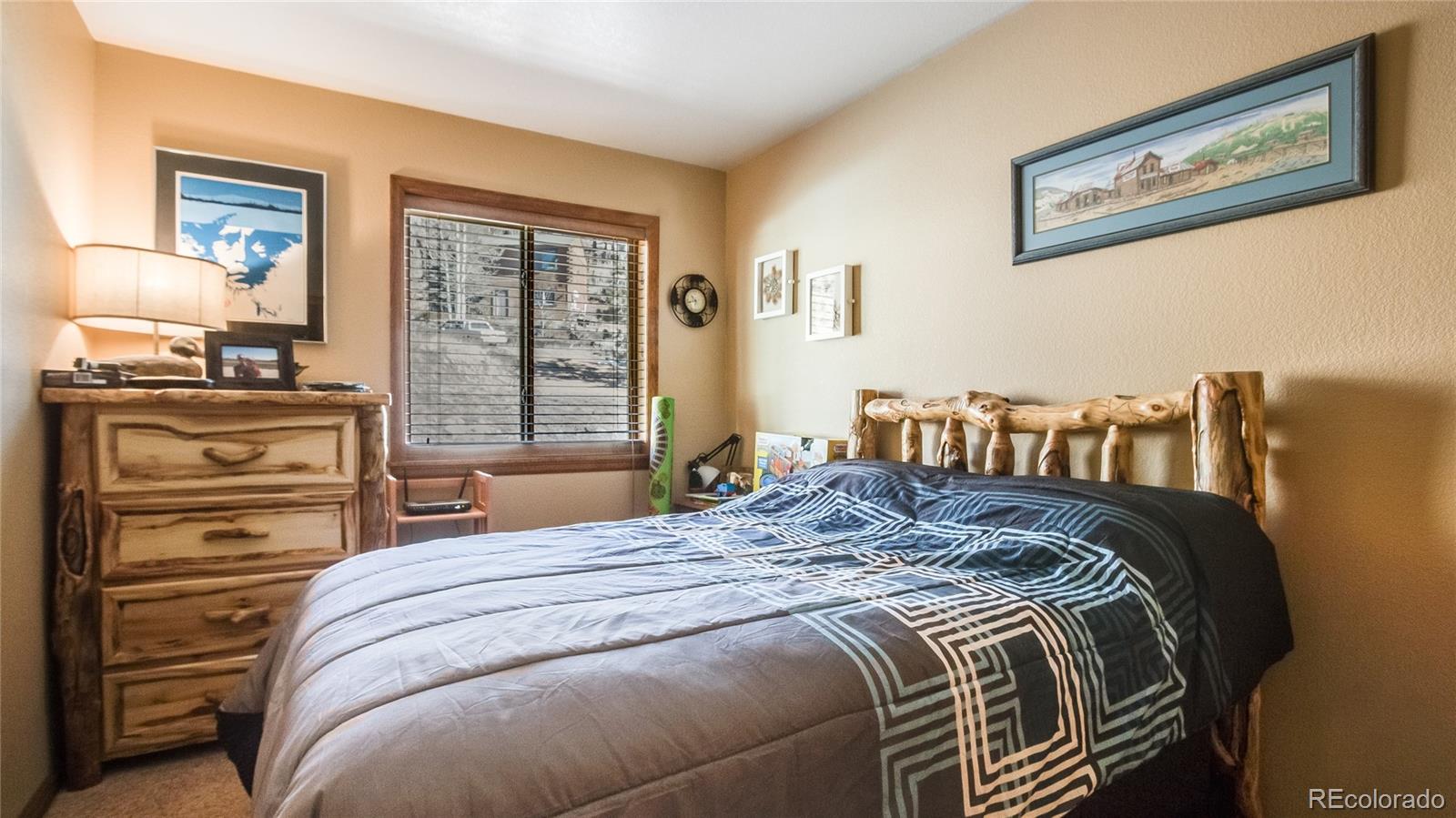 302 Bishop Road Bailey, CO 80421 - Photo 12 of 19 a bedroom with a bed and wooden floor